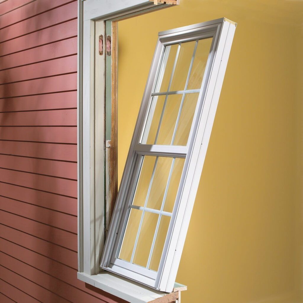 Insert replacement window being installed into existing window frame