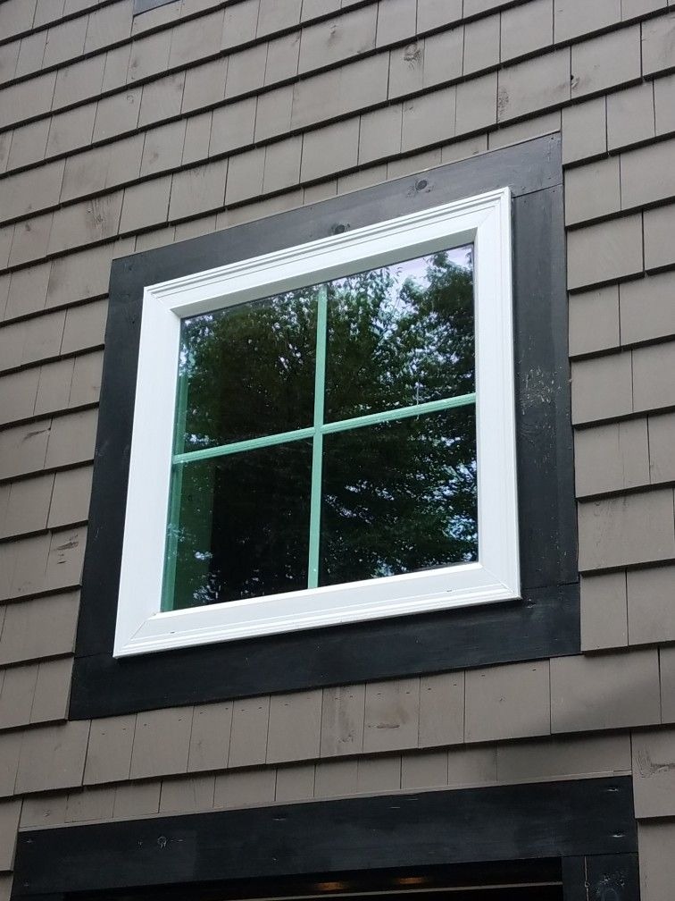Square window with white trim and black exterior frame